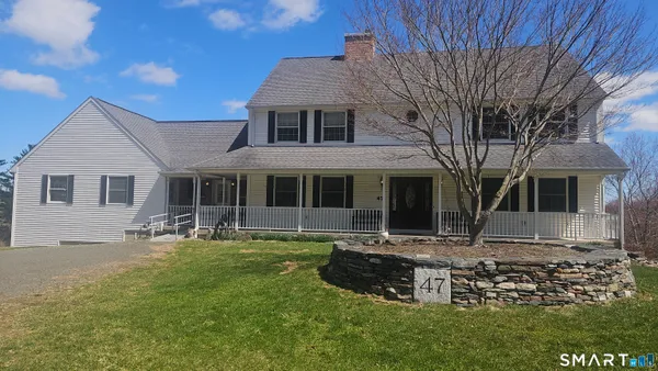 a front view of house with yard outdoor seating and barbeque oven
