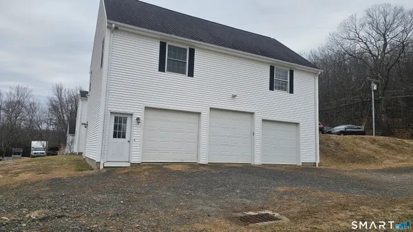 a view of a house with a yard and garage