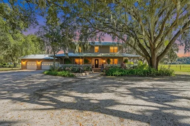a front view of a building with trees