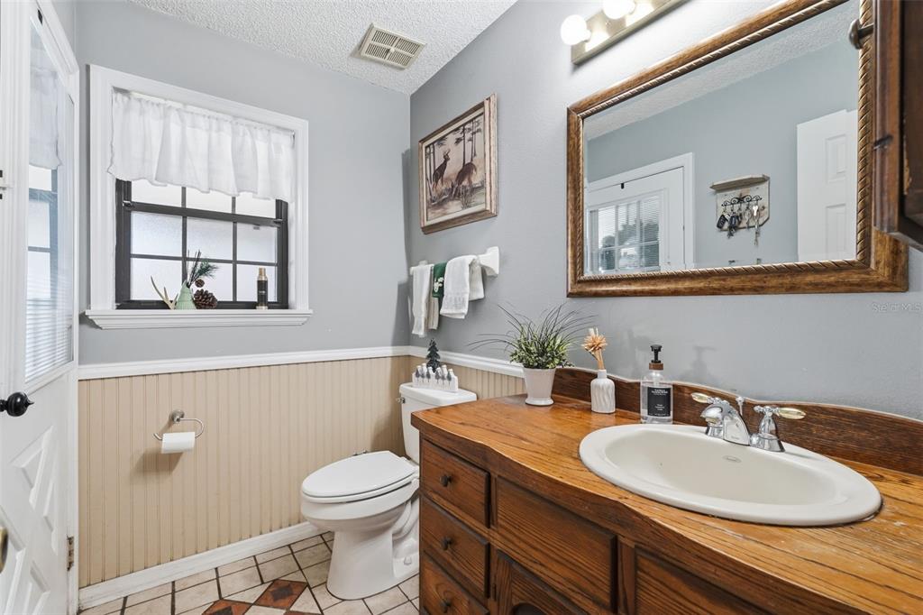 2911 Walker Road Lakeland, FL 33810 - Photo 12 of 70 a bathroom with a granite countertop toilet a sink and mirror