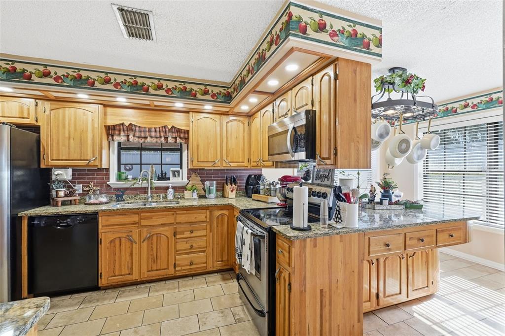 2911 Walker Road Lakeland, FL 33810 - Photo 15 of 70 a kitchen with a sink stove and cabinets
