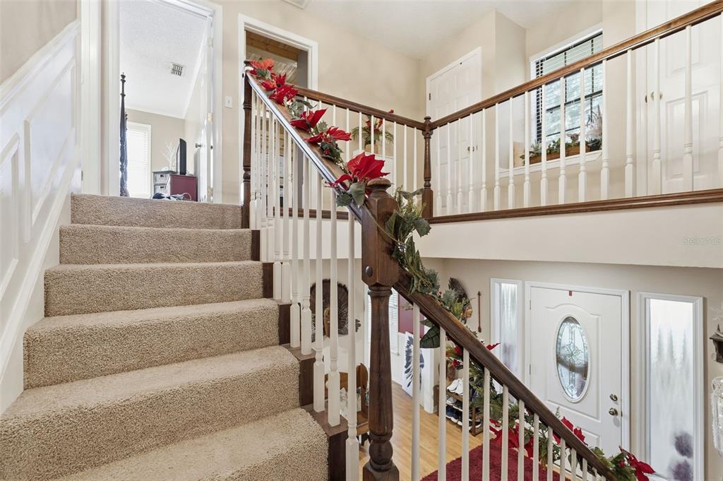 2911 Walker Road Lakeland, FL 33810 - Photo 24 of 70 a view of staircase with lots of frames on wall and a window