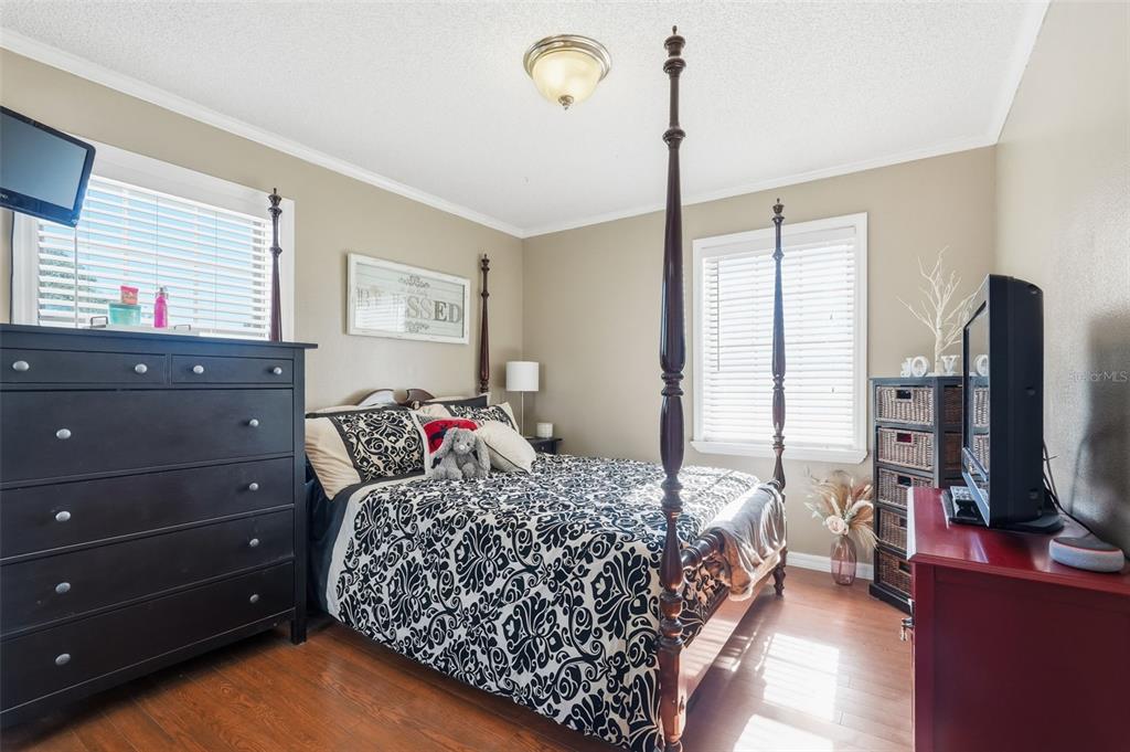 2911 Walker Road Lakeland, FL 33810 - Photo 26 of 70 a bedroom with a bed and a flat tv screen on dresser