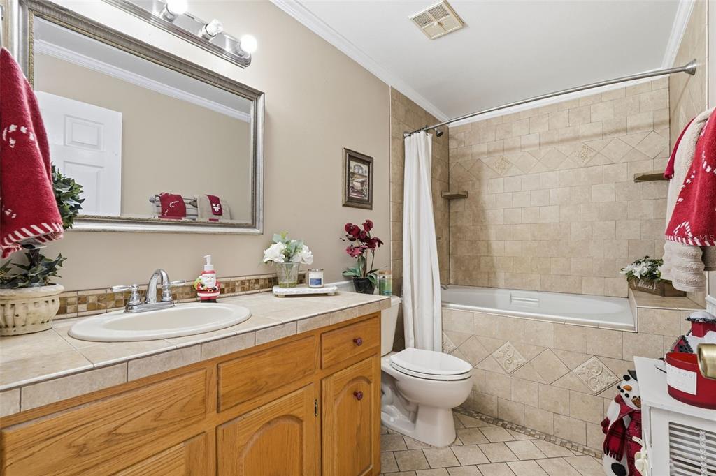2911 Walker Road Lakeland, FL 33810 - Photo 29 of 70 a bathroom with a sink a toilet and shower