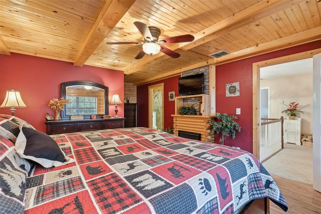 2911 Walker Road Lakeland, FL 33810 - Photo 37 of 70 a bedroom with a large bed and a chandelier