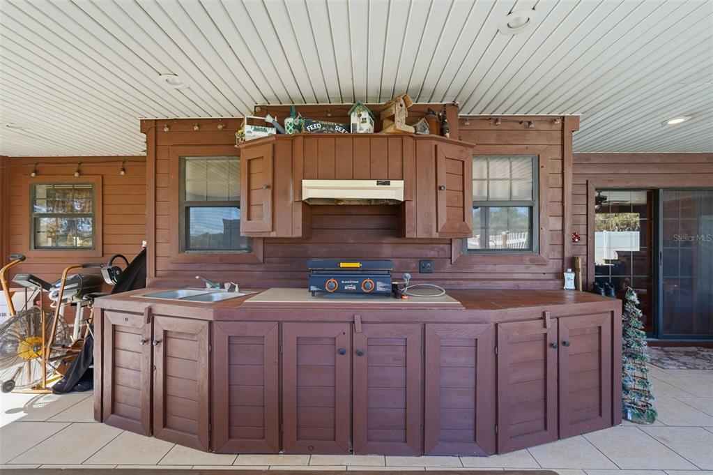 2911 Walker Road Lakeland, FL 33810 - Photo 43 of 70 a kitchen with cabinets a counter space and a sink
