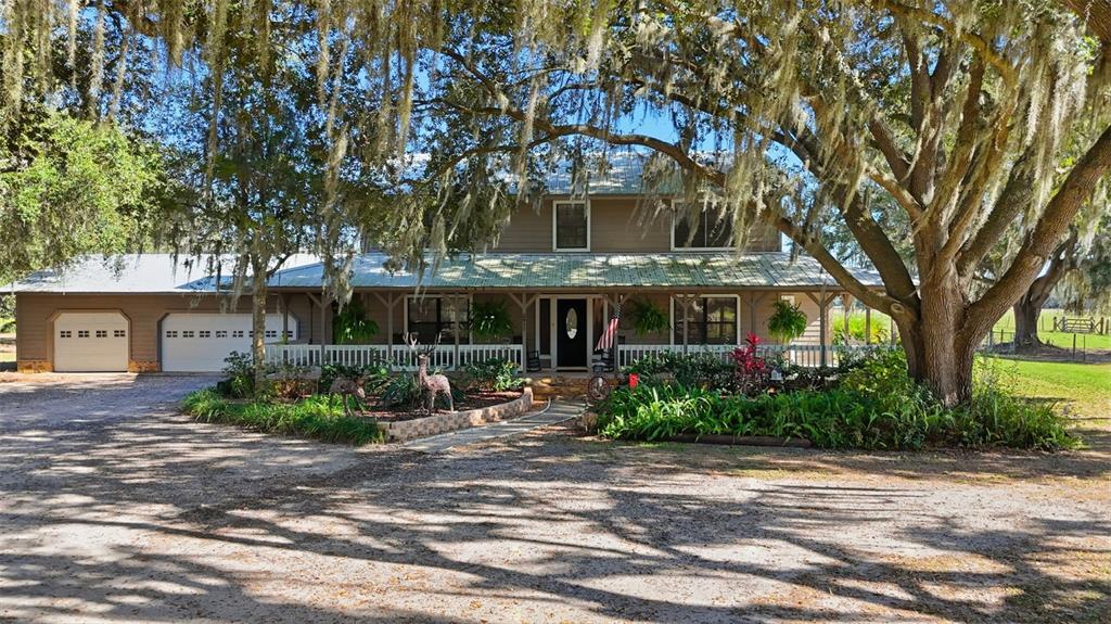 2911 Walker Road Lakeland, FL 33810 - Photo 49 of 70 a front view of a house with a yard and potted plants