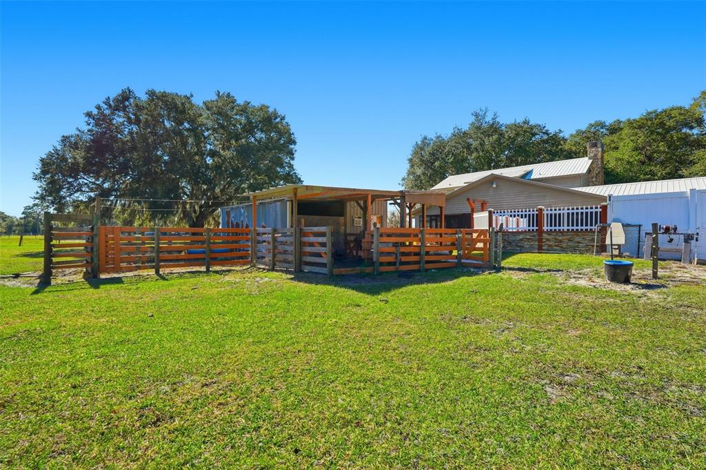 2911 Walker Road Lakeland, FL 33810 - Photo 53 of 70 a view of a house with a yard table and chairs