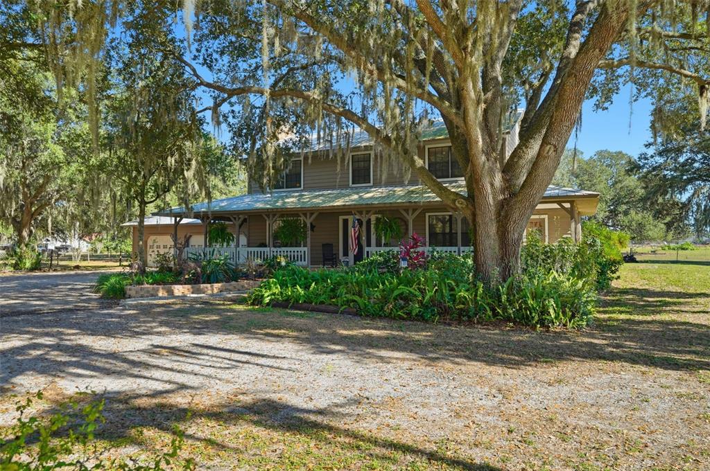 2911 Walker Road Lakeland, FL 33810 - Photo 60 of 70 a front view of a house with a garden