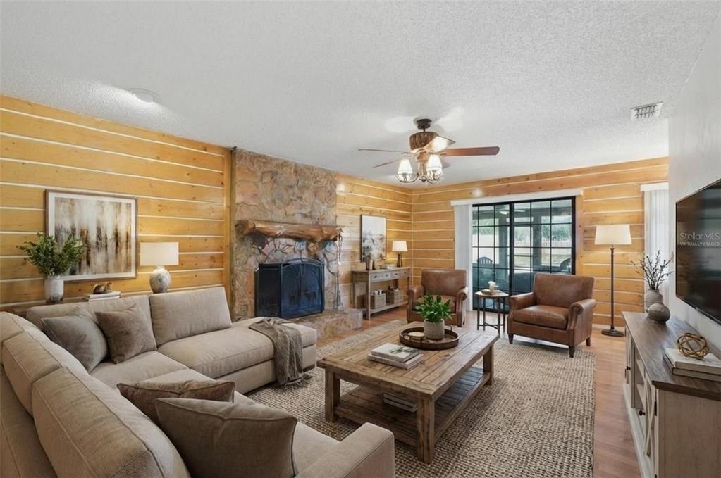 2911 Walker Road Lakeland, FL 33810 - Photo 8 of 70 a living room with furniture a fireplace and a flat screen tv