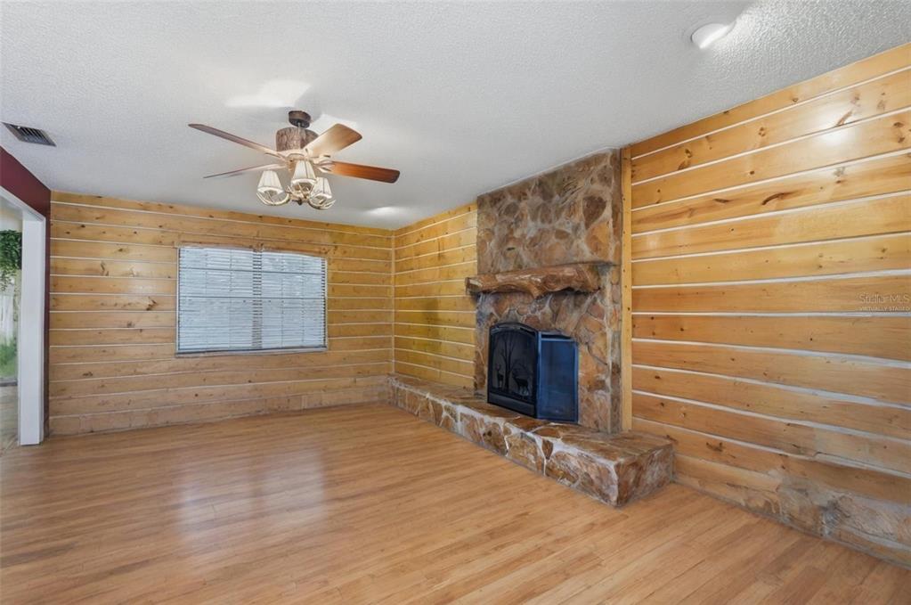 2911 Walker Road Lakeland, FL 33810 - Photo 9 of 70 a view of an empty room with a fireplace and a window