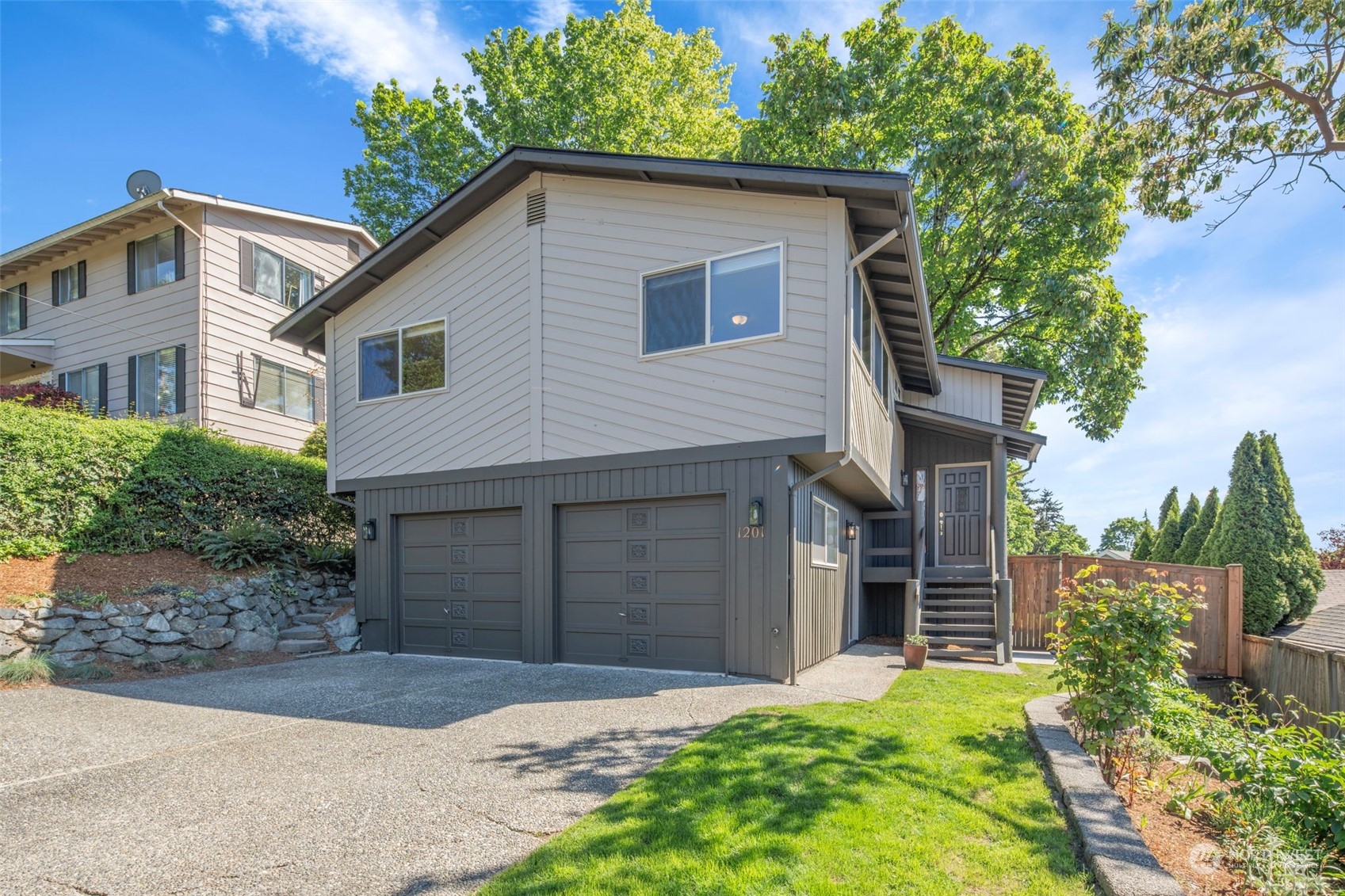 1201 North 28th Place Renton, WA 98056 - Photo 1 of 25 a front view of a house with a yard and garage