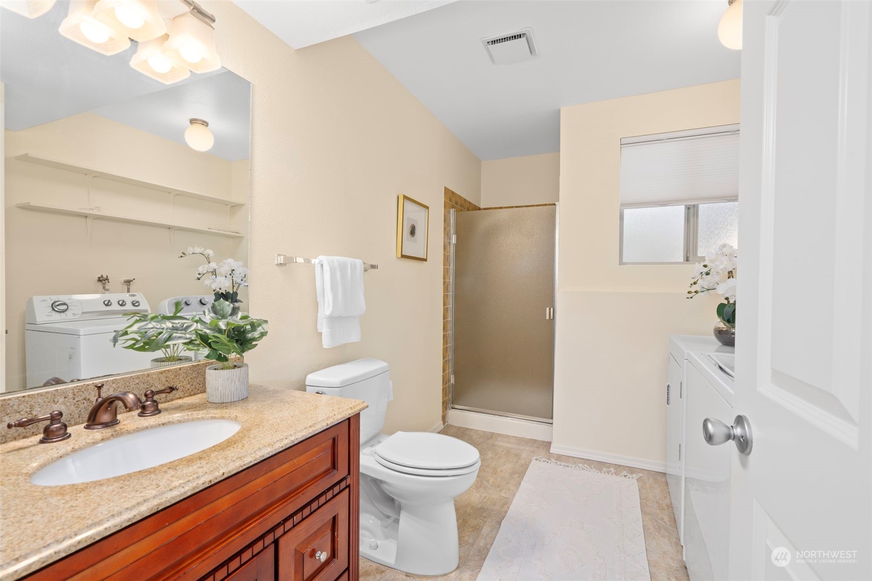 1201 North 28th Place Renton, WA 98056 - Photo 17 of 25 a bathroom with a granite countertop sink toilet a large mirror a shower and a mirror