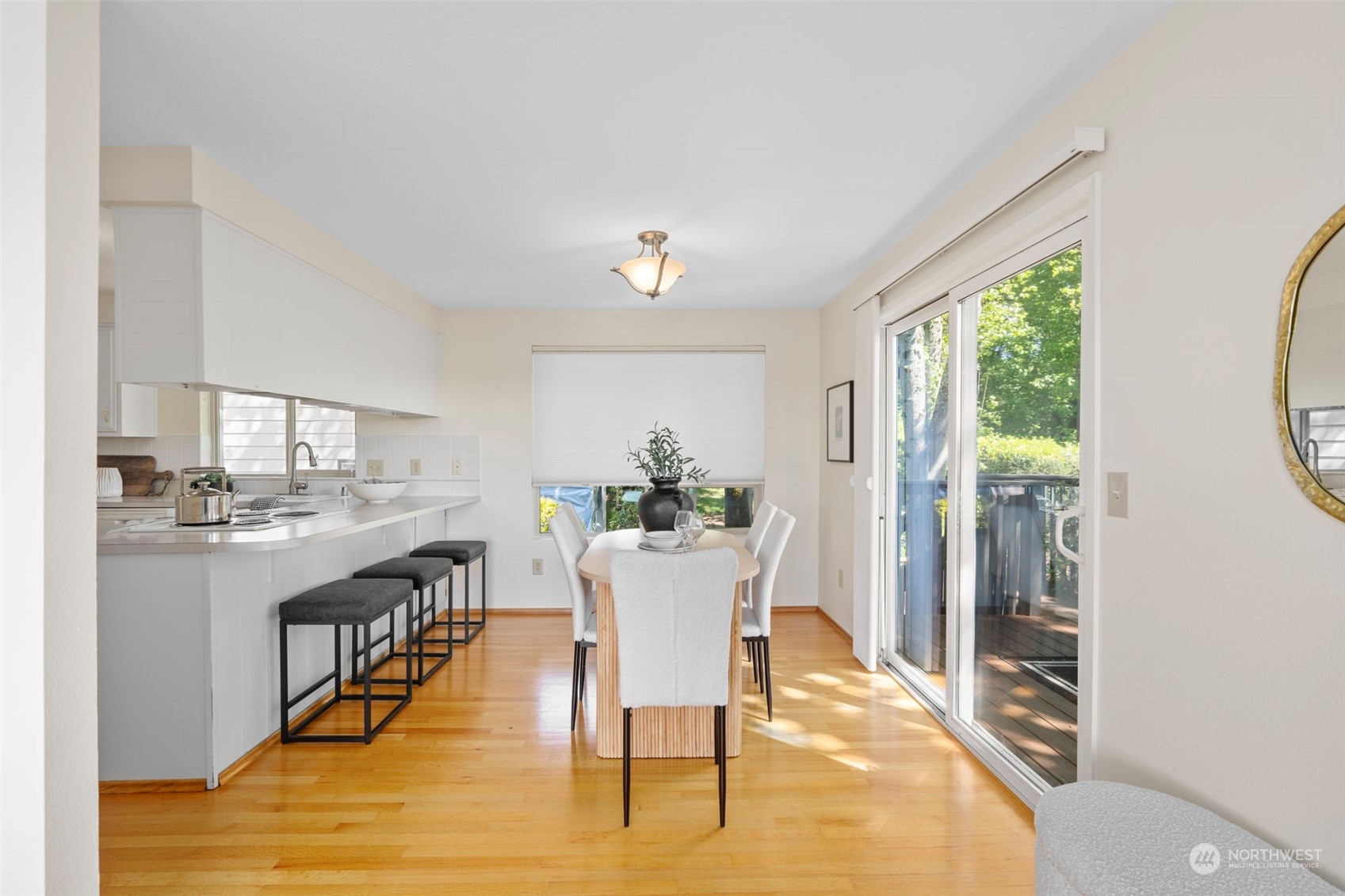 1201 North 28th Place Renton, WA 98056 - Photo 5 of 25 a view of a dining room with furniture window and wooden floor