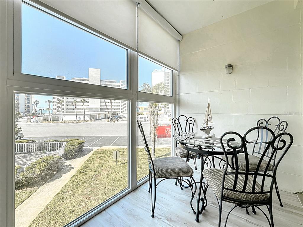 7050 Sunset Way, Unit 22 St. Pete Beach, FL 33706 - Photo 16 of 30 a view of a chairs and table in the balcony