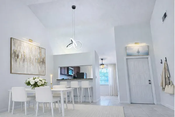 a view of a dining room with furniture and a flat screen tv