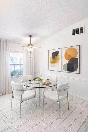 a dining room with furniture and window