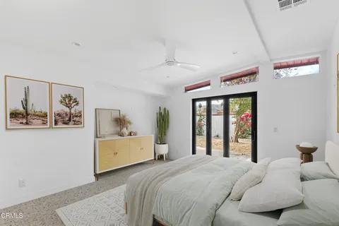 a bedroom with a large bed and a window