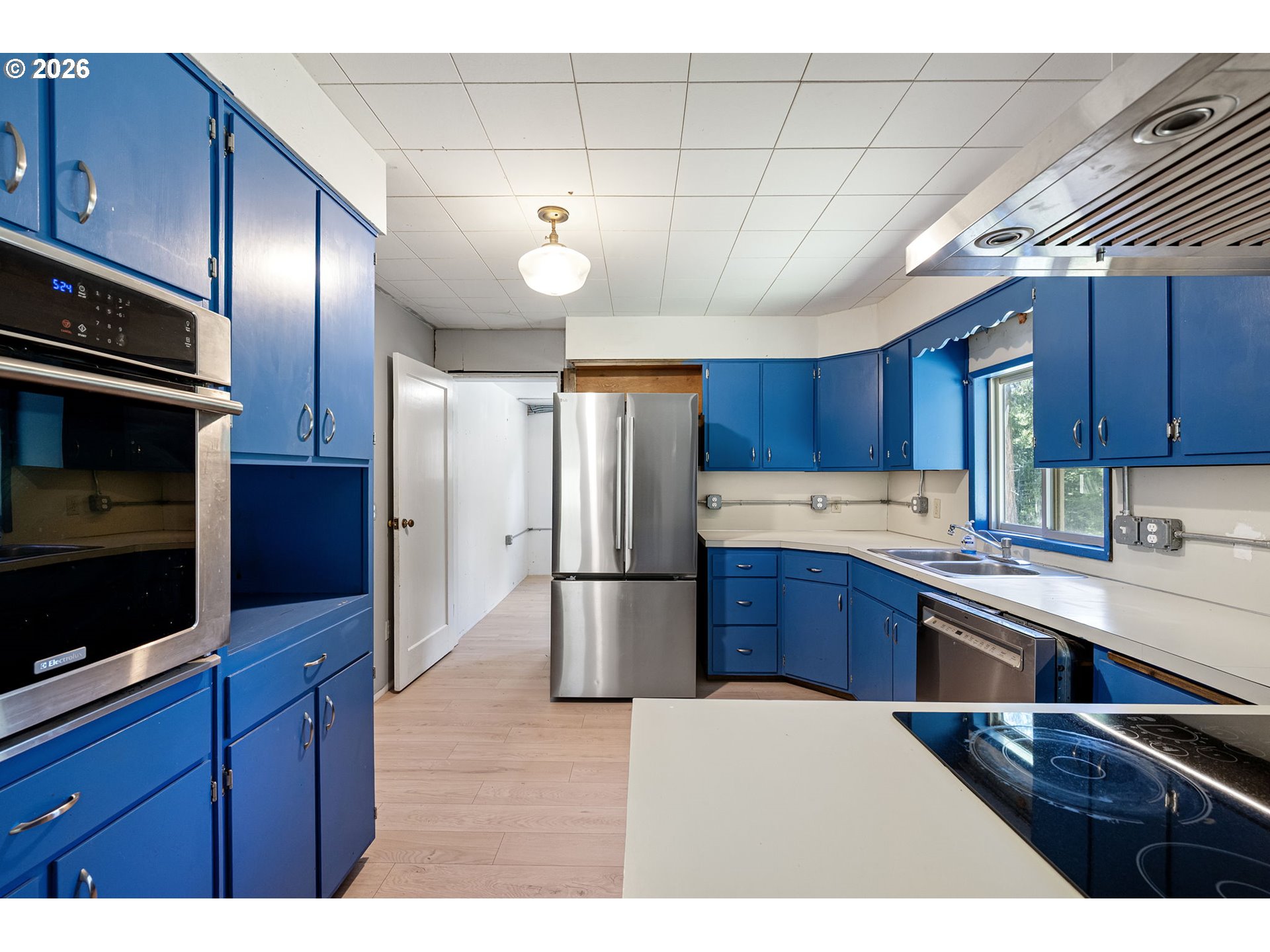 77521 Brock Road Oakridge, OR 97463 - Photo 11 of 48 a kitchen with stainless steel appliances wooden cabinets a stove a sink and a refrigerator