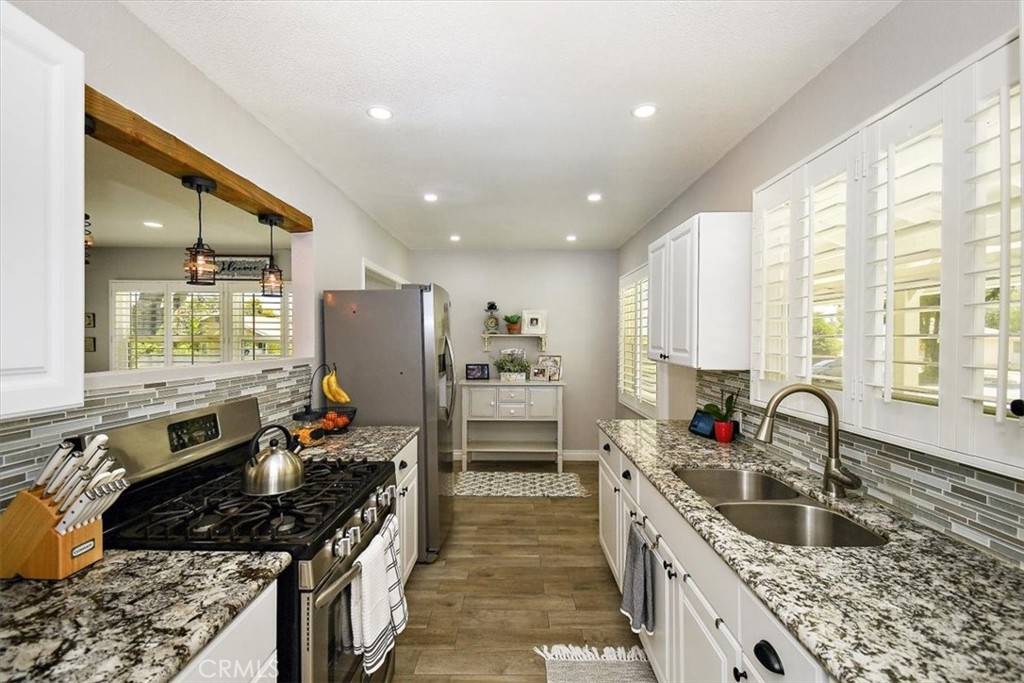 3315 Spring Garden Street Riverside, CA 92501 - Photo 11 of 38 a kitchen with stainless steel appliances granite countertop a sink stove and refrigerator