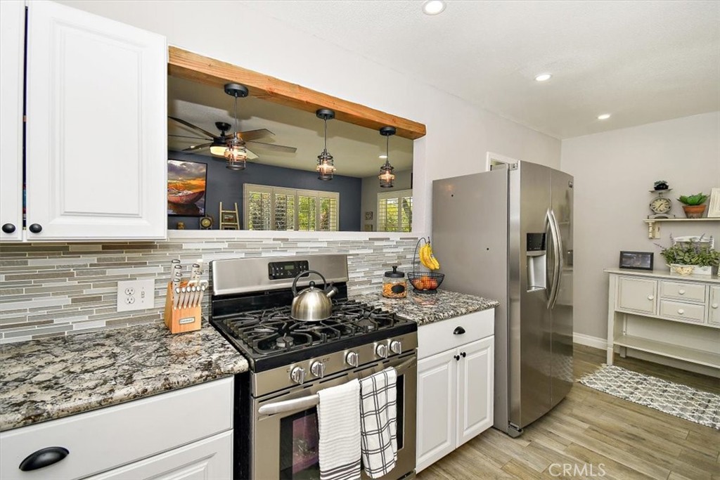 3315 Spring Garden Street Riverside, CA 92501 - Photo 12 of 38 a kitchen with stainless steel appliances granite countertop a sink stove and refrigerator
