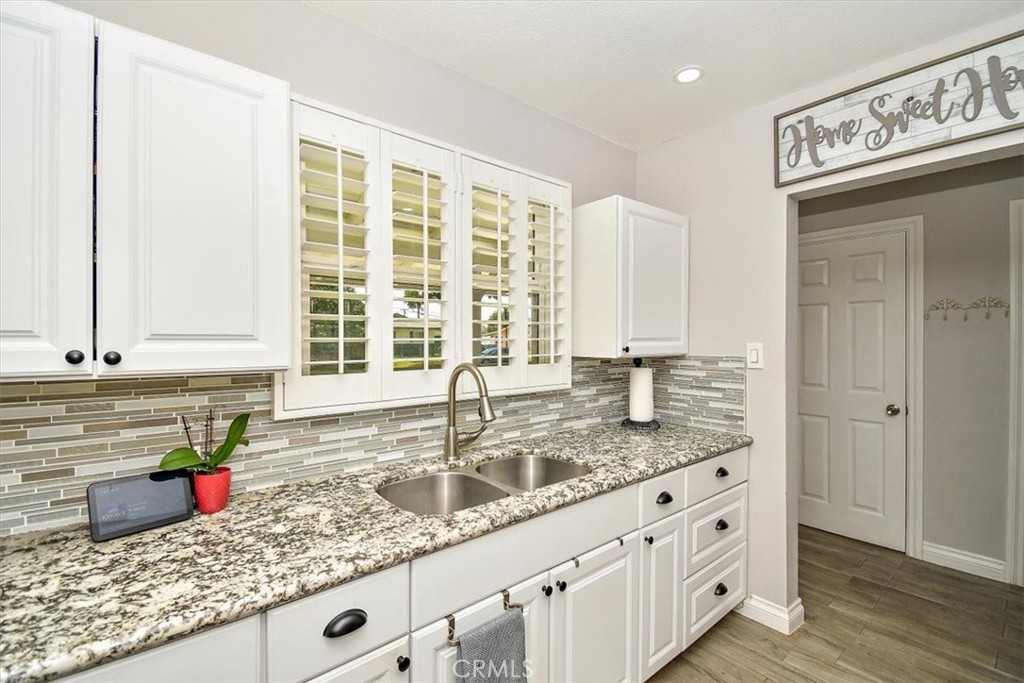 3315 Spring Garden Street Riverside, CA 92501 - Photo 13 of 38 a kitchen with granite countertop a sink and a window