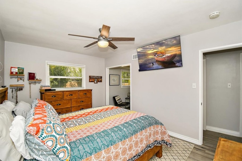 3315 Spring Garden Street Riverside, CA 92501 - Photo 15 of 38 a bedroom with a bed a dresser and a window