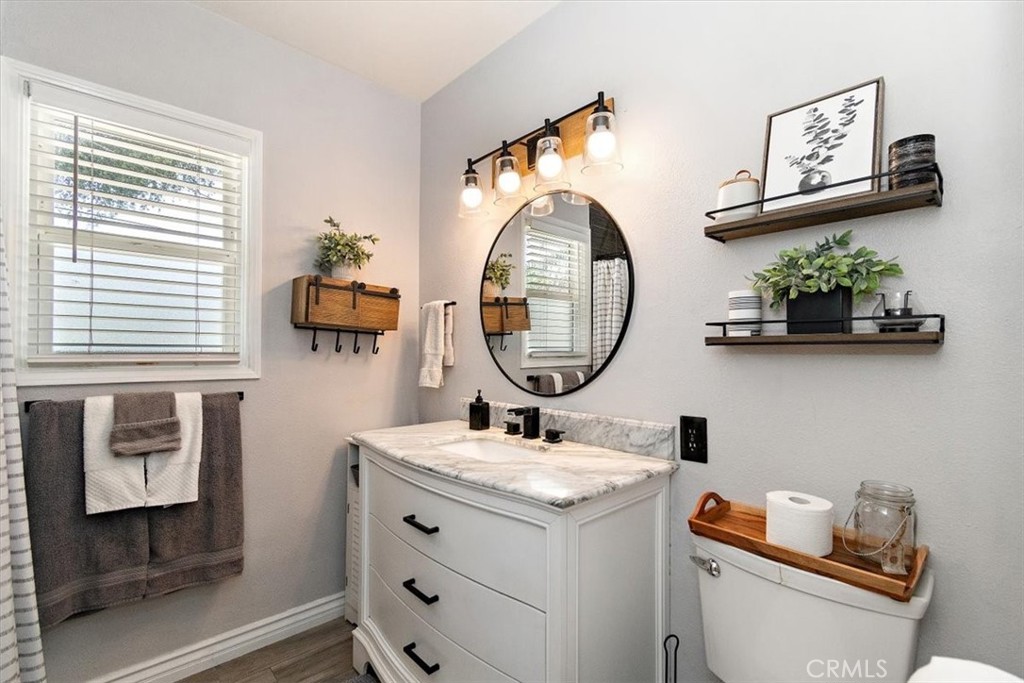 3315 Spring Garden Street Riverside, CA 92501 - Photo 22 of 38 a bathroom with a toilet sink and mirror