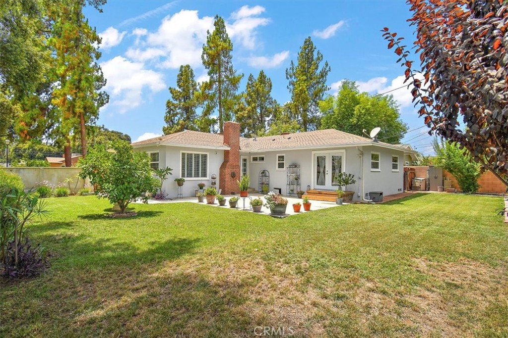 3315 Spring Garden Street Riverside, CA 92501 - Photo 26 of 38 a front view of a house with a yard table and chairs
