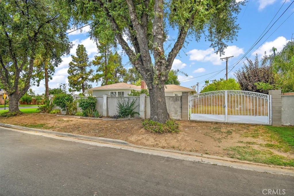 3315 Spring Garden Street Riverside, CA 92501 - Photo 34 of 38 a white house that has a tree in front of it