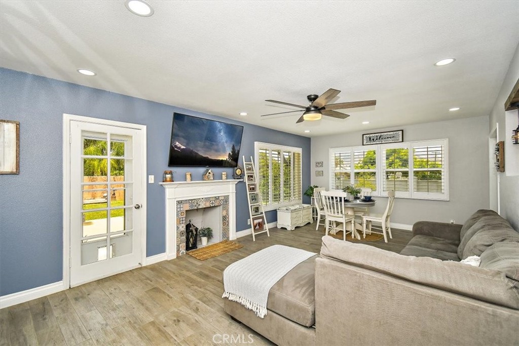 3315 Spring Garden Street Riverside, CA 92501 - Photo 5 of 38 a living room with furniture a fireplace and a flat screen tv