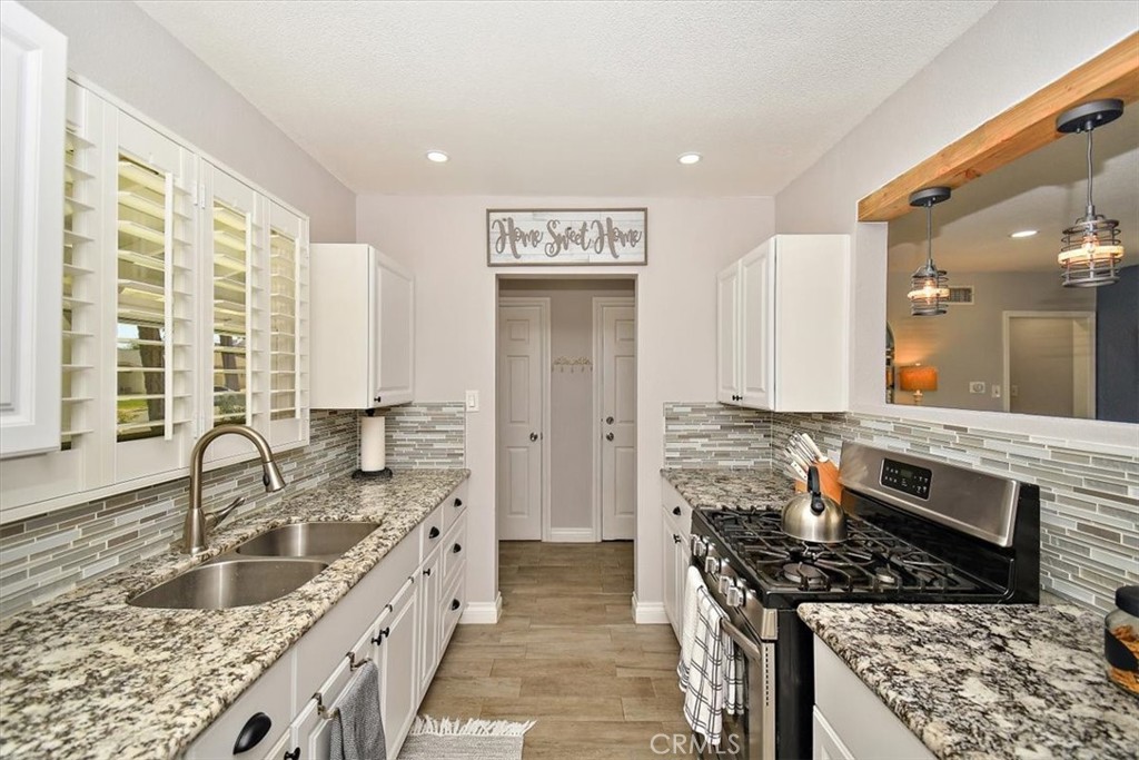 3315 Spring Garden Street Riverside, CA 92501 - Photo 10 of 38 a kitchen with stainless steel appliances granite countertop a sink stove and cabinets