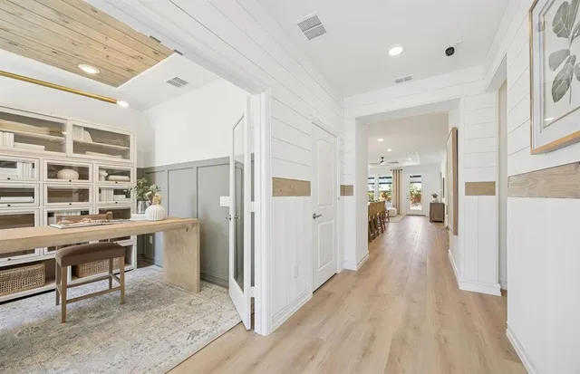a view of a hallway and wooden floor windows
