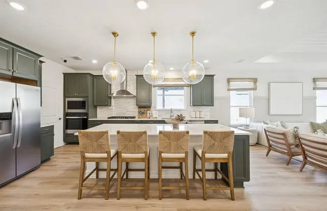 a large kitchen with a table and chairs