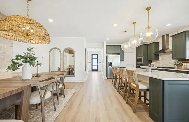 a large kitchen with a table and chairs