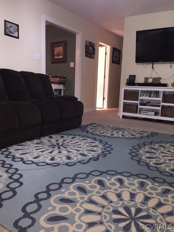 20256 Beaver Dam Road Beaverdam, VA 23015 - Photo 8 of 12 a living room with a couch and a flat screen tv
