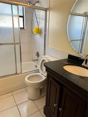 a bathroom with a sink toilet and mirror