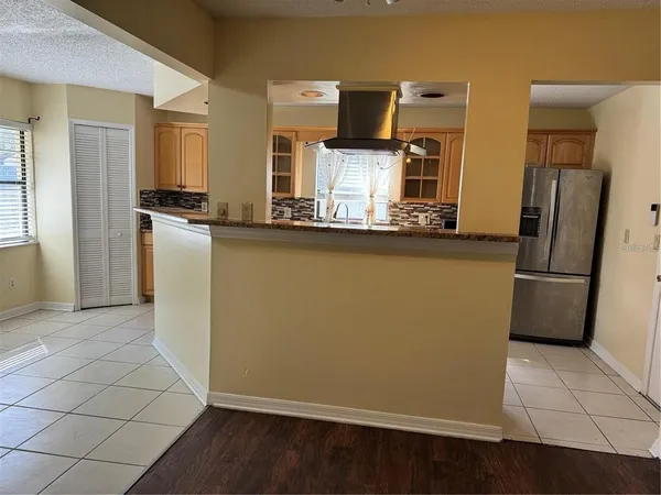 a kitchen with stainless steel appliances a refrigerator and a stove top oven