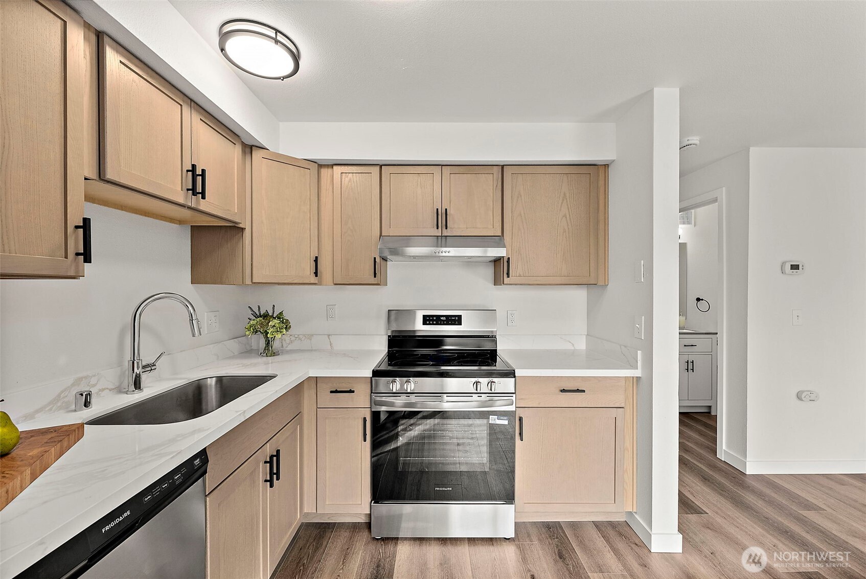 3939 10th Street Southeast, Unit G4 Puyallup, WA 98374 - Photo 1 of 25 a kitchen with cabinets stainless steel appliances and a sink