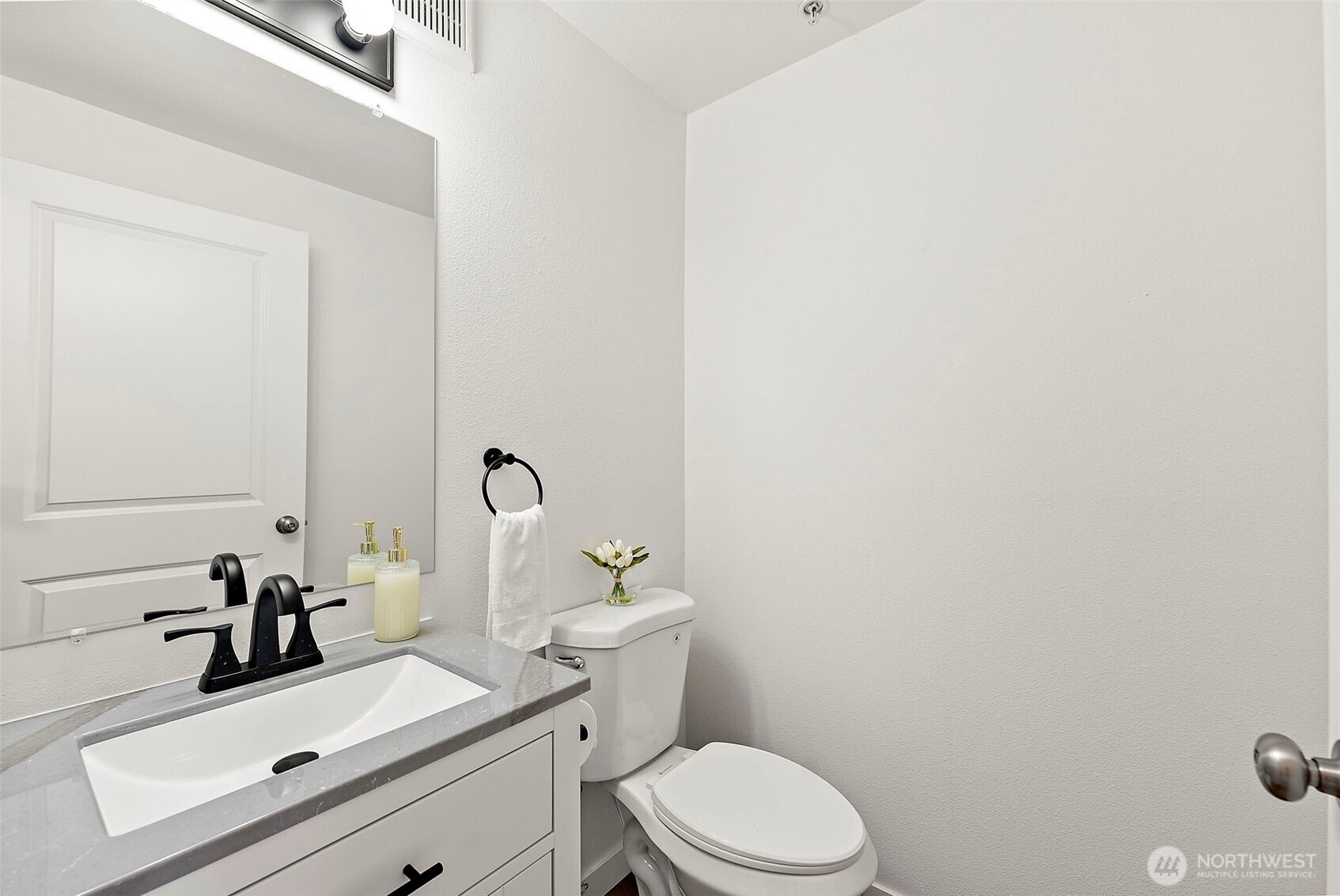 3939 10th Street Southeast, Unit G4 Puyallup, WA 98374 - Photo 12 of 25 a bathroom with a sink a toilet and mirror