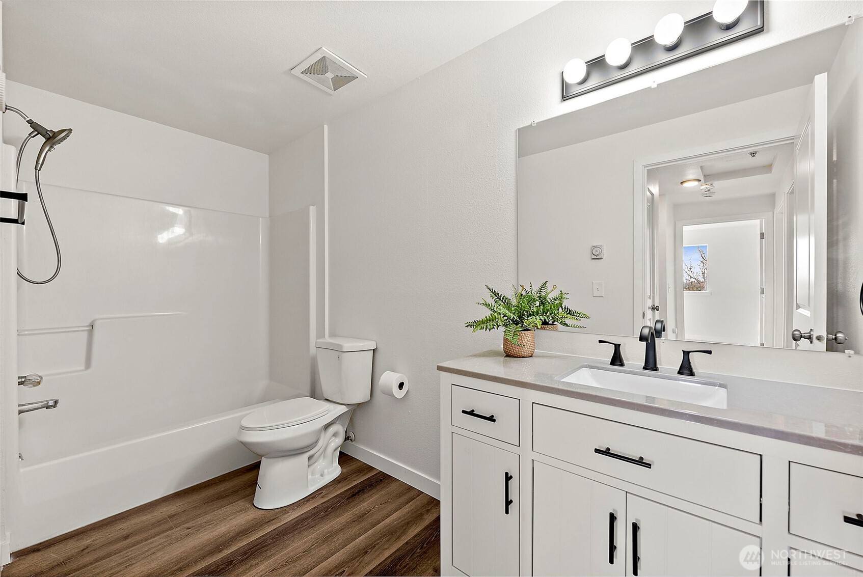 3939 10th Street Southeast, Unit G4 Puyallup, WA 98374 - Photo 14 of 25 a bathroom with a sink toilet a mirror and shower