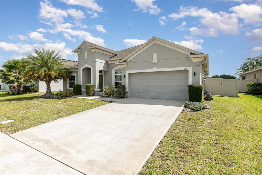 1807 Westerham Avenue St. Cloud, FL 34771 - Photo 1 of 1 a front view of a house with a yard and garage