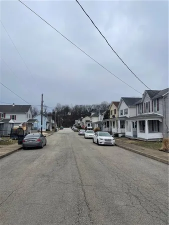 a view of a city street with a parked cars