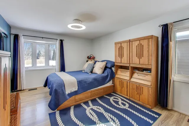 a bed sitting in a bedroom next to a window