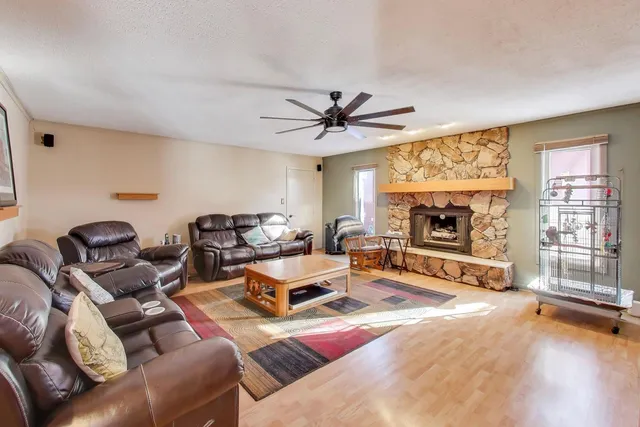 a living room with furniture a fireplace and a flat screen tv