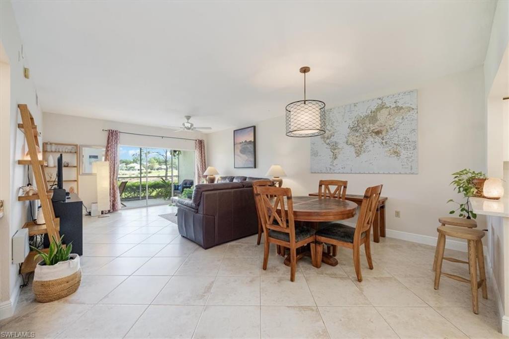 6025 Chardonnay Lane, Unit 103 Naples, FL 34119 - Photo 12 of 45 a view of a dining room with furniture window and wooden floor