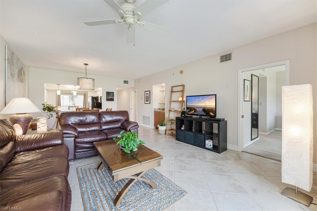 6025 Chardonnay Lane, Unit 103 Naples, FL 34119 - Photo 13 of 45 a living room with furniture and wooden floor