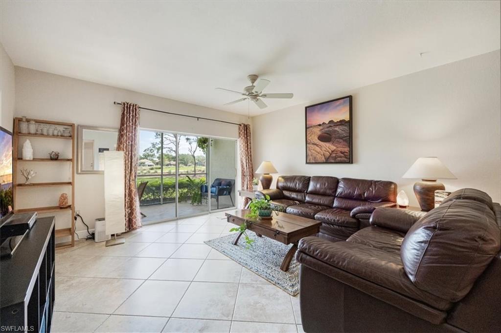 6025 Chardonnay Lane, Unit 103 Naples, FL 34119 - Photo 15 of 45 a living room with furniture and a flat screen tv