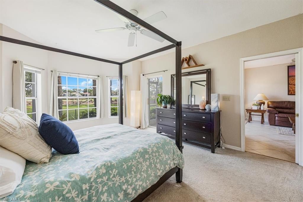 6025 Chardonnay Lane, Unit 103 Naples, FL 34119 - Photo 24 of 45 a spacious bedroom with a large bed and a dresser