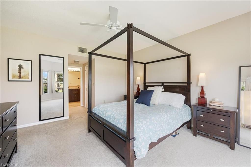 6025 Chardonnay Lane, Unit 103 Naples, FL 34119 - Photo 25 of 45 a bed room with a bed and a dresser